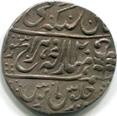 A close-up of a coin

Description automatically generated