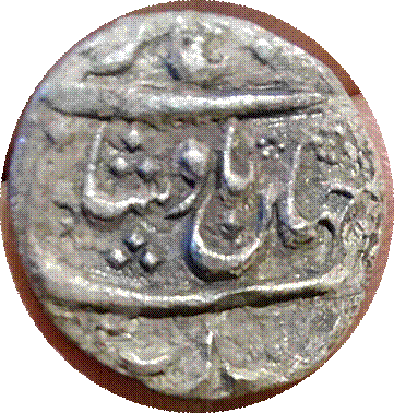 A close-up of a coin

Description automatically generated with medium confidence